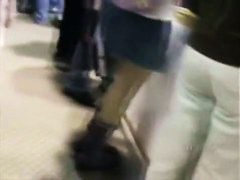 A hip tanned brunette in a hat has her ass filmed in an upskirt porno