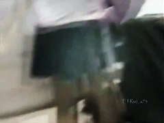 A hip tanned brunette in a hat has her ass filmed in an upskirt porno