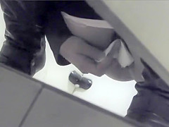 Asian girl gets filmed in a public toilet