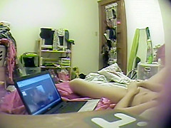 Asian girl watches porn and rubs pussy