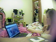 Asian girl watches porn and rubs pussy