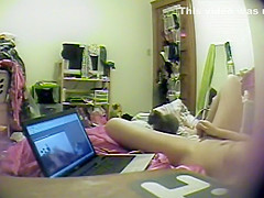 Asian girl watches porn and rubs pussy