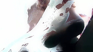 Beautiful girls wash an expensive car