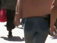 Beautiful street candid is being video taped by a guy