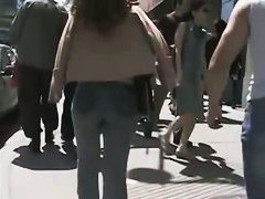 Beautiful street candid is being video taped by a guy