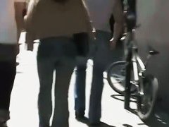Beautiful street candid is being video taped by a guy