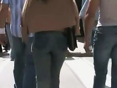 Beautiful street candid is being video taped by a guy