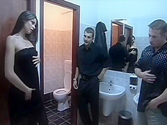 Black Haired Girl Is On Her Knees Jerking And Sucking Two Cocks At Once