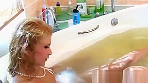 Blonde teenage model takes a bath