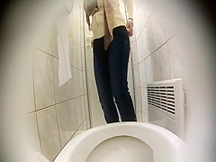 Blonde woman sits and pees