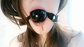 Bound girl with ball gag gets messy