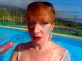 British Mature Red XXX sucking cock in a pool