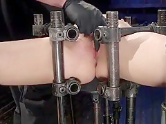 Brunette in device bondage anal fucked