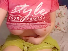 Busty sexy with glasses penetrates her wet pussy with a dildo in her bedroom