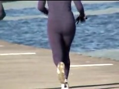 Candid ass milf is running along the golden beach 08i