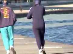 Candid ass milf is running along the golden beach 08i