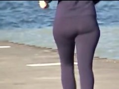 Candid ass milf is running along the golden beach 08i