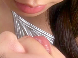 Charming Japanese beauties giving a kiss with light spitting