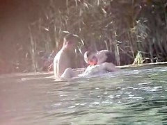 Curvaceous slug receiving two massive cock on the nudist beach