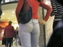 Cute brunette walking her ass in tight jeans on candid cam