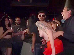 Gagged brunette tormented in public bar