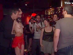Gagged brunette tormented in public bar
