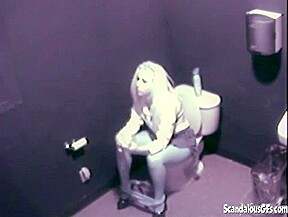 Hot Blonde fingering her pussy public toilet