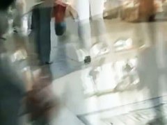 Hot brunette w/ a nice ass in a voyur porno pacing in a shopping mall