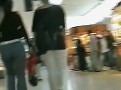 Hot brunette w/ a nice ass in a voyur porno pacing in a shopping mall