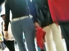 Hot brunette w/ a nice ass in a voyur porno pacing in a shopping mall