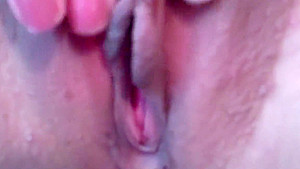 Lusty babe touches her tits and rubs her cunt in bed