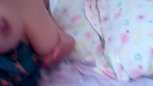 Lusty babe touches her tits and rubs her cunt in bed