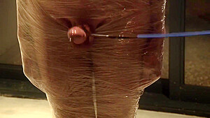 Male Slave Bound In Cling Wrap Gets Riding Crop Cbt By Two Gorgeous Femdoms