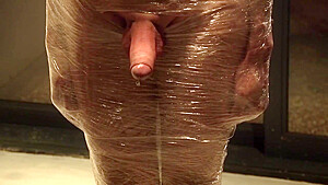 Male Slave Bound In Cling Wrap Gets Riding Crop Cbt By Two Gorgeous Femdoms