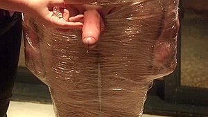 Male Slave Bound In Cling Wrap Gets Riding Crop Cbt By Two Gorgeous Femdoms