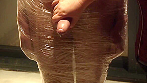Male Slave Bound In Cling Wrap Gets Riding Crop Cbt By Two Gorgeous Femdoms