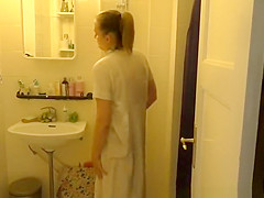 Nurse with her wet uniform in bathroom