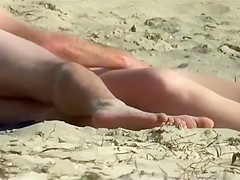 Playing with his wife on the beach gets him a blowjob