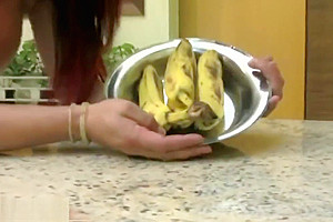 Redhead T-girl in see through dress enjoys her banana rama