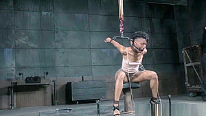 Restrained ebony sub drools during punishment