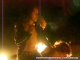 Smoking Mistress Sits on Slave