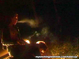 Smoking Mistress Sits on Slave