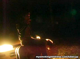 Smoking Mistress Sits on Slave