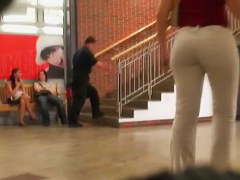 Street booty catches a woman flexing her butt in tight jeans