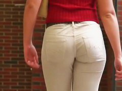 Street booty catches a woman flexing her butt in tight jeans