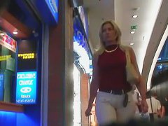 Street booty catches a woman flexing her butt in tight jeans
