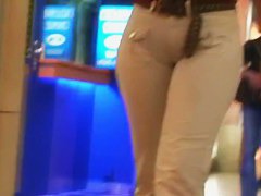 Street booty catches a woman flexing her butt in tight jeans