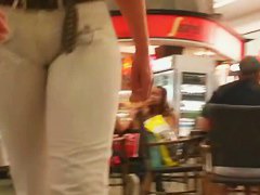 Street booty catches a woman flexing her butt in tight jeans