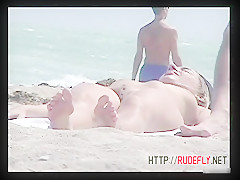 Stunning tanned brunette with a neat pussy in a beach porno video