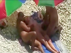 Threesome sex fun on public beach caught on cam